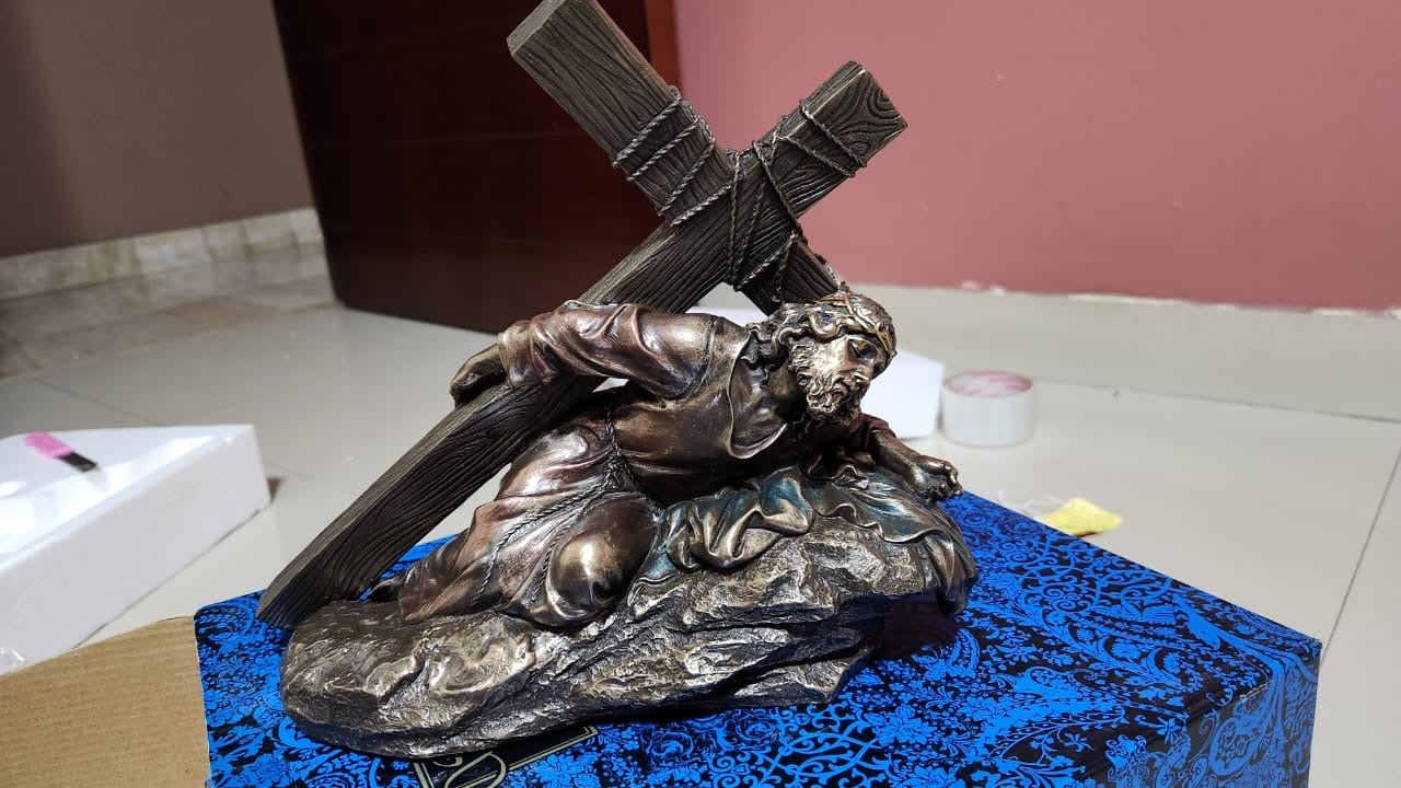 Jesus Christ Caring a cross in bronze color