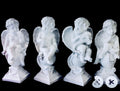 Four white angel statues on a white background
